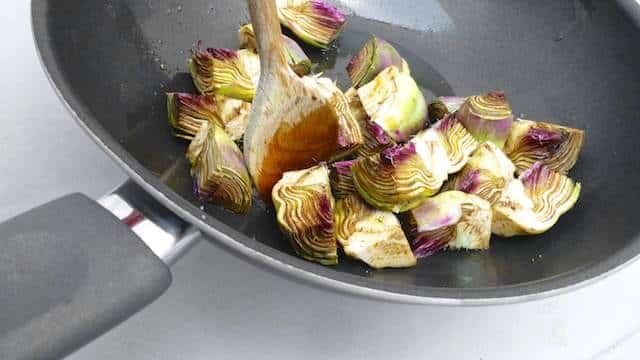 fry and cook artichokes in a pan